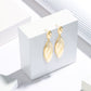 The Gilded Feather Drop Earrings – High-Gloss Luxe Finish